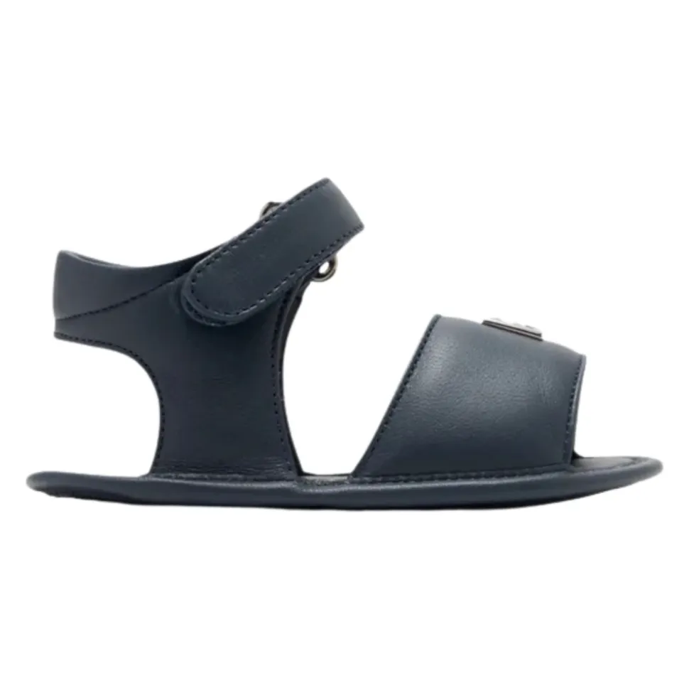 Sandaler i lammeskinn med 3D metallogo